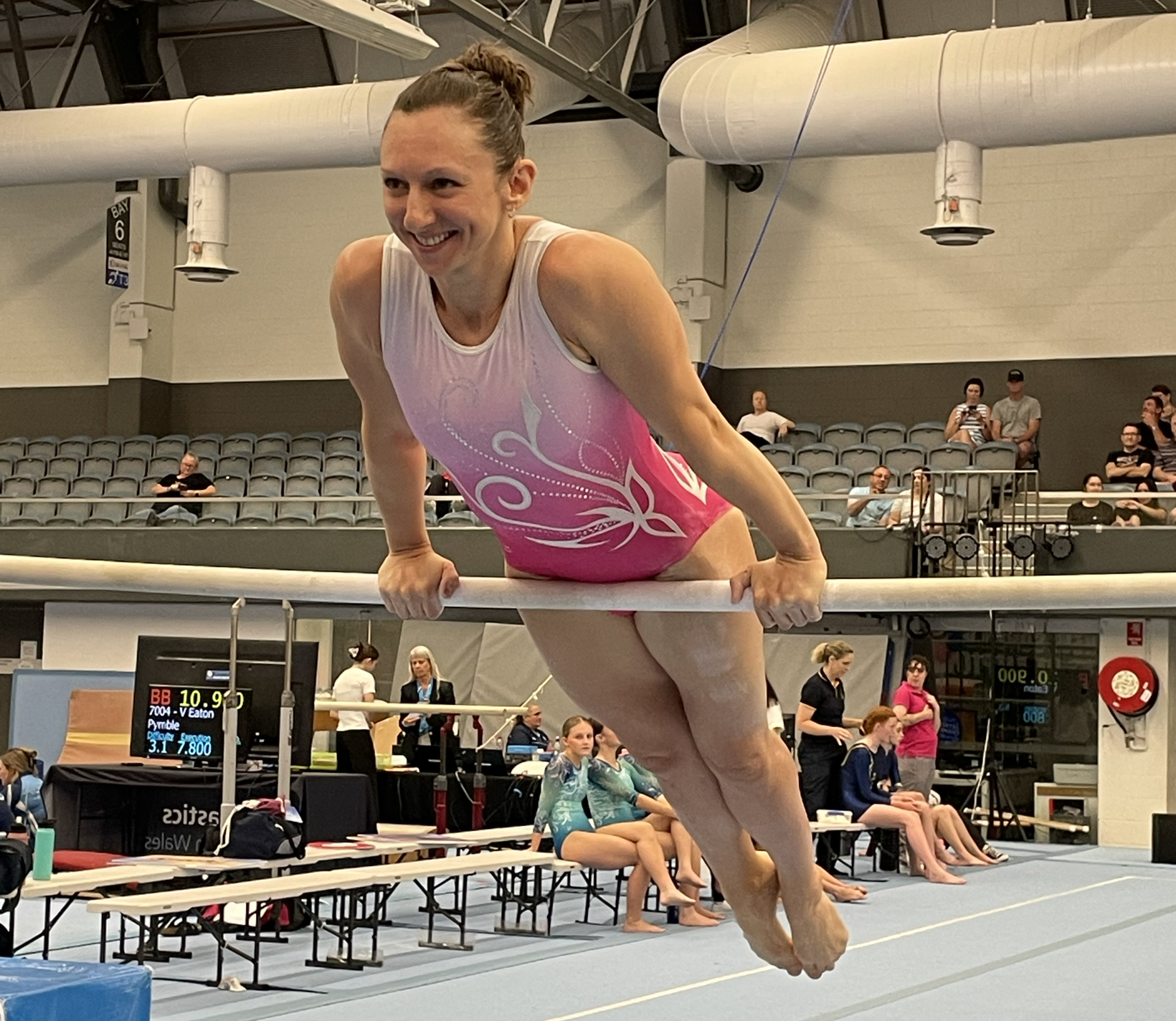 Woman smiling on gymnastics bar